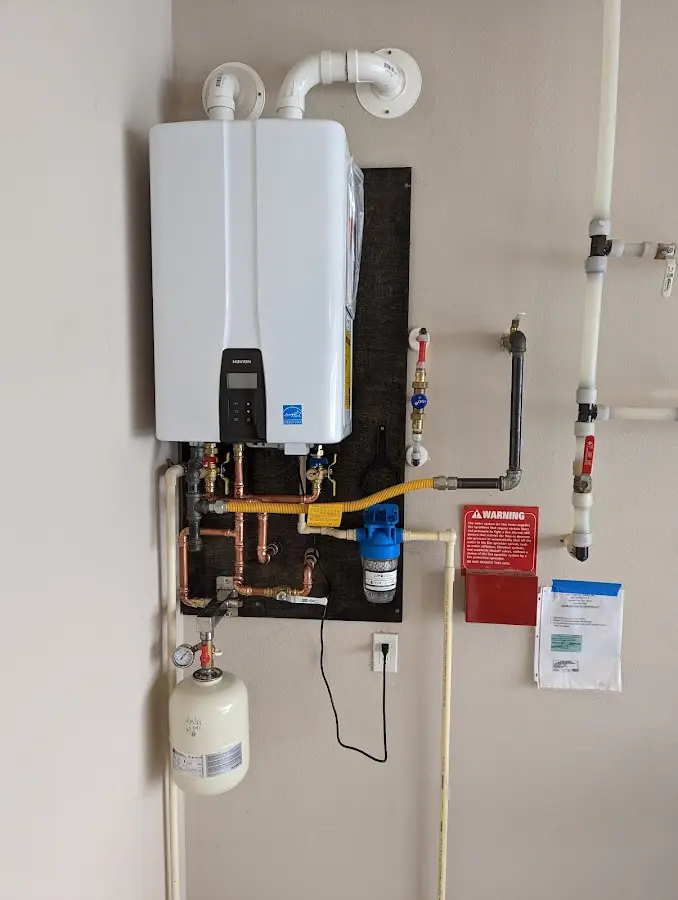 Professional plumber installing copper piping in a Derby home